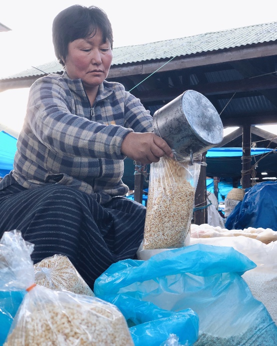 Woman selling roasted rice in Punakha, Bhutan